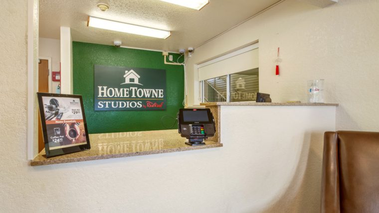 Interior of a HomeTowne Studios and Suites extended stay hotel lobby