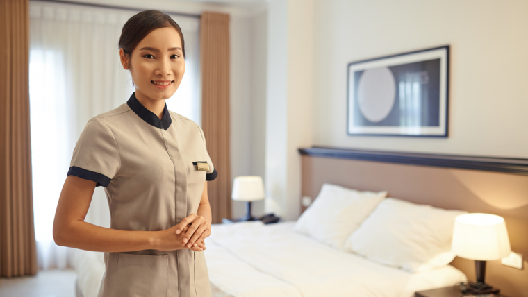 extended stay jobs hotel staff housekeeper standing in a fresh hotel room