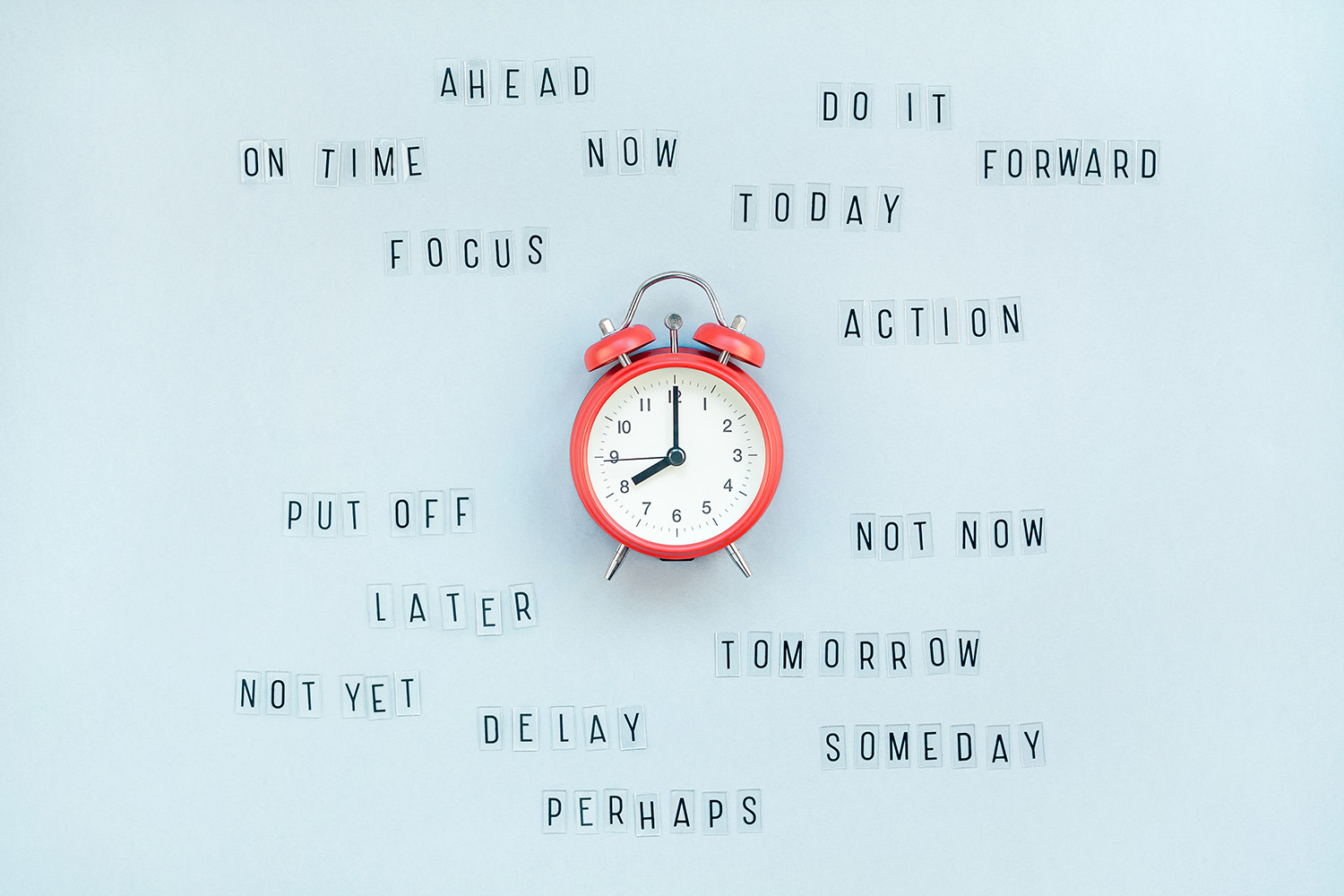 Clock on blue background as a concept of procrastination and time management